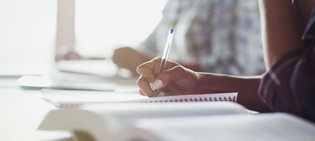 Student writing notes